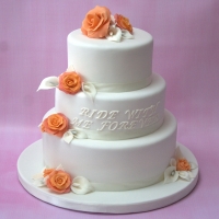 Orange rose &amp; lily wedding cake