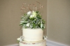 Semi-naked wedding cake flower topper close-up