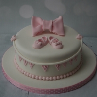 Pink baby shoes baby shower cake