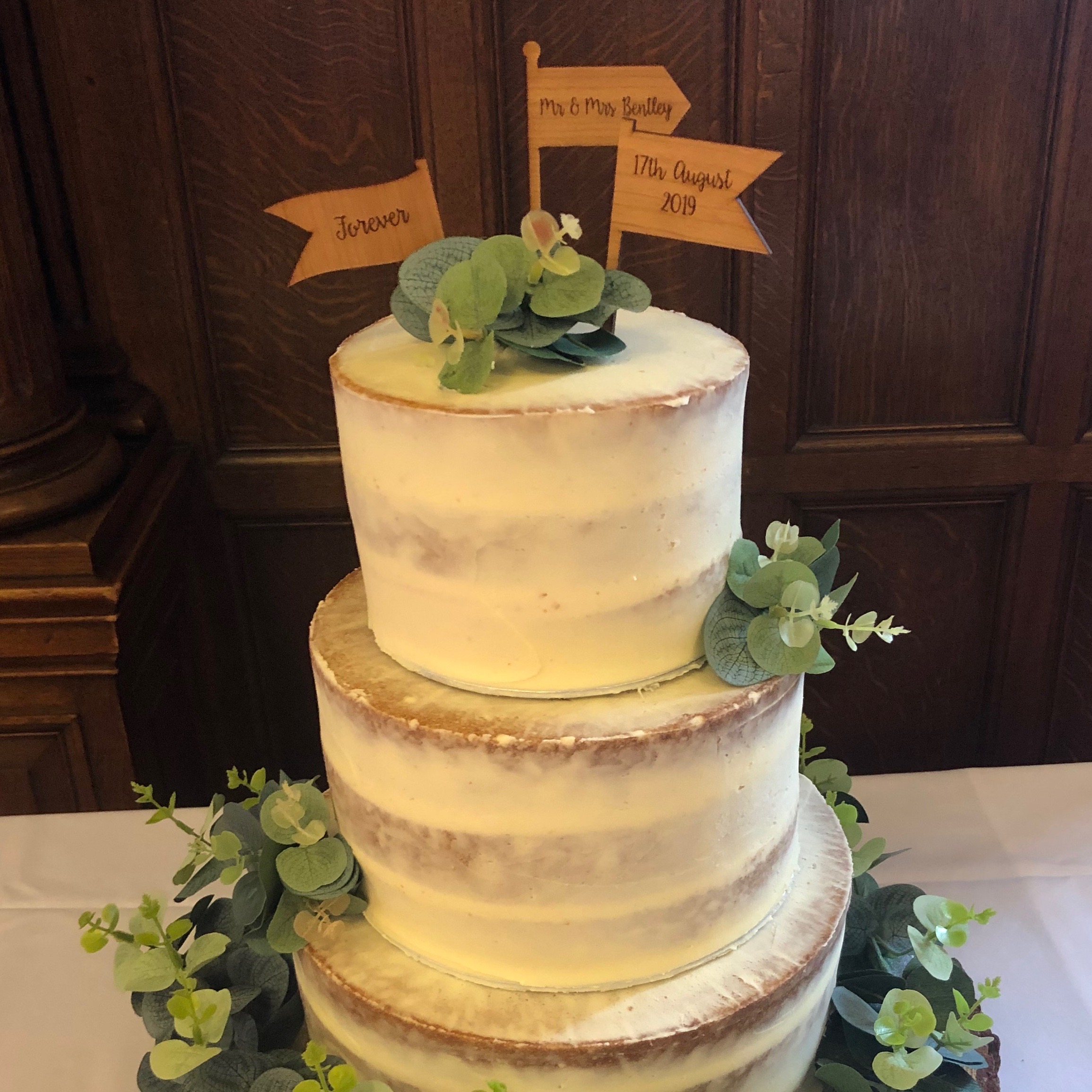 Semi-naked wedding cake with eucalyptus leaves