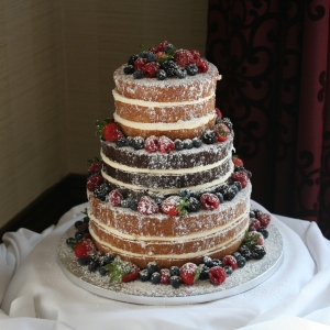 3 tier &#039;naked&#039; wedding cake with fresh fruit