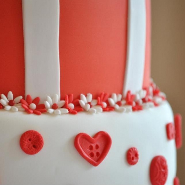 Red &amp; White wedding cake button close up