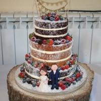 3 tier naked wedding cake with clay figures